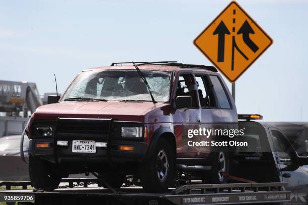 The vehicle that the Austin package bomber, Mark Anthony Conditt, was driving when he blew himself up is towed from the crime scene along Interstate...