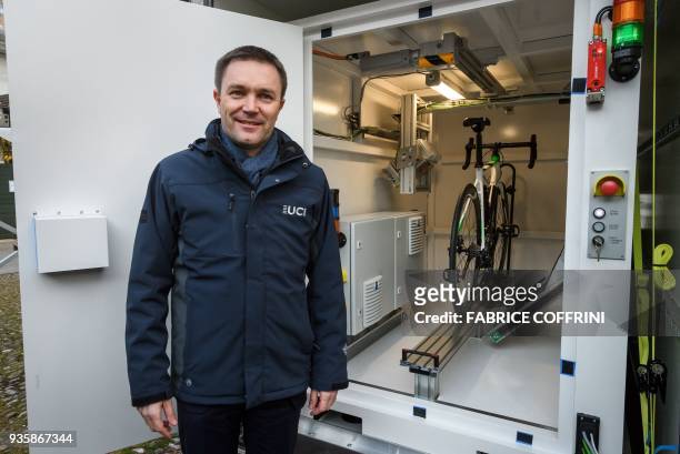 International Cycling Union president David Lappartient poses next to a new mobile X-ray machine box during a press conference unveilling a beefed-up...
