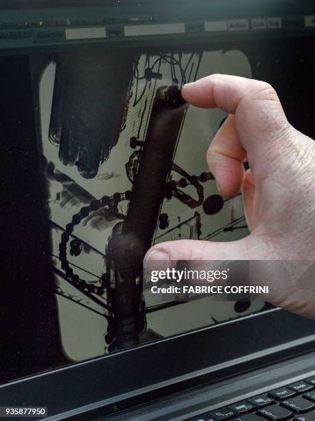 Technician shows a X-ray picture showing a device in the frame of a bicycle during the presentation by International Cycling Union of a mobile X-ray...