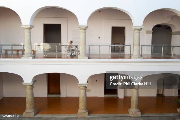 Man sits at a table in the Museo de Arte Contemporaneo de Oaxaca / Oaxaca Museum of Contemporary Art in the Casa de Cortes. Oaxaca is known...