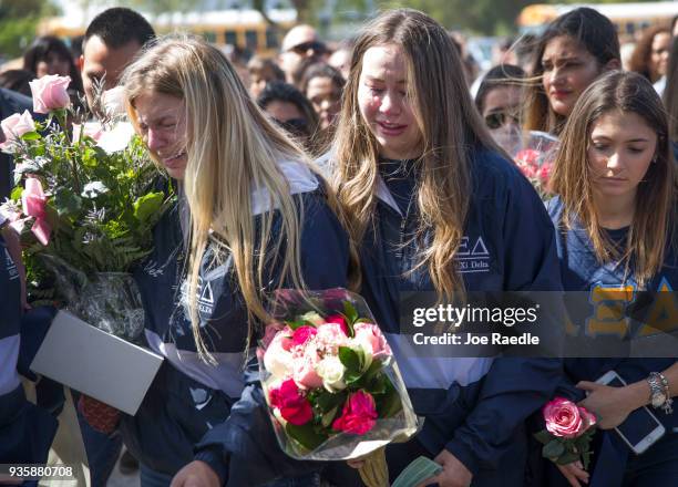 Friends, family, Florida International faculty and students mourn together during a vigil for victims of last week's pedestrian bridge collapse on...