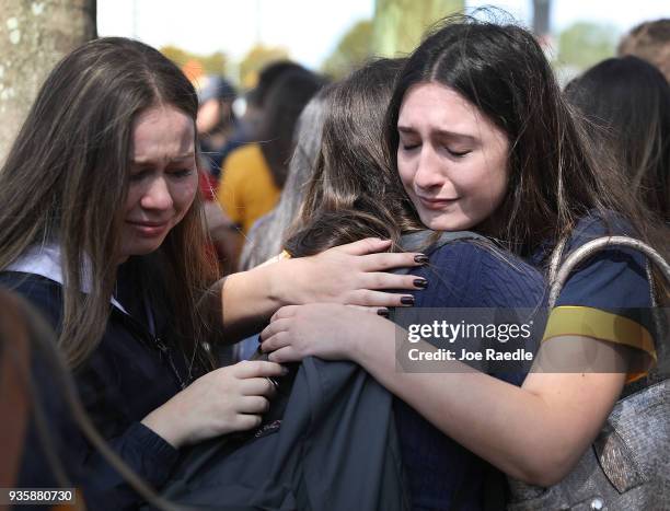 Friends, family, Florida International faculty and students mourn together during a vigil for victims of last week's pedestrian bridge collapse on...