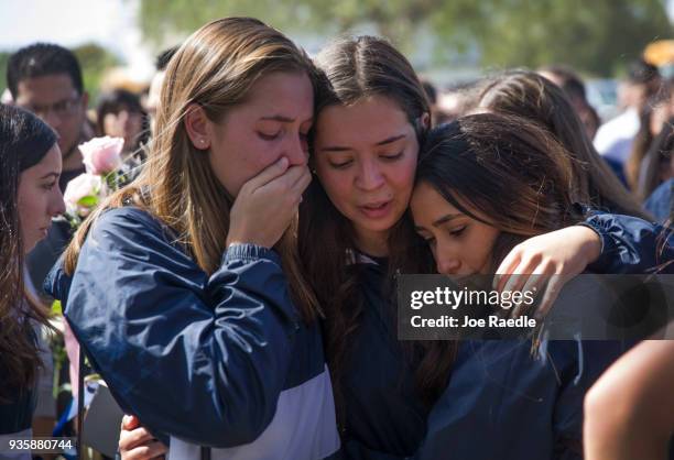 Friends, family, Florida International faculty and students mourn together during a vigil for victims of last week's pedestrian bridge collapse on...