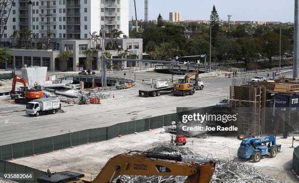 The site of last weeks pedestrian bridge collapse is seen as people attend a vigil for victims of the collapse on the Florida International...