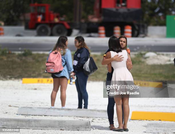 Friends, family, Florida International University faculty and students mourn together during a vigil for victims of last week's pedestrian bridge...