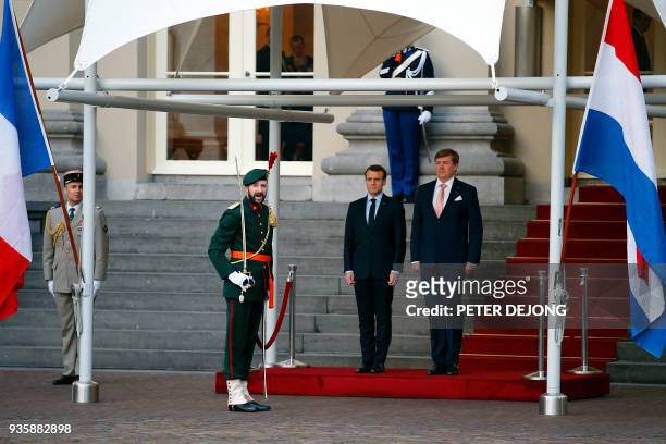 French President Emmanuel Macron , and Dutch King Willem-Alexander listen to the national anthem prior to inspecting the honor guard at royal palace...