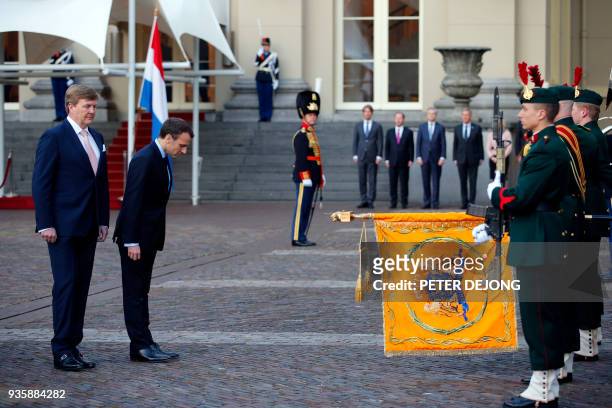 French President Emmanuel Macron , and Dutch King Willem-Alexander inspect the honor guard at royal palace Noordeinde in The Hague on March 21, 2018....