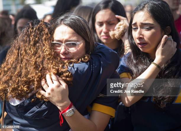 Friends, family, Florida International University faculty and students mourn together during a vigil for victims of last week's pedestrian bridge...