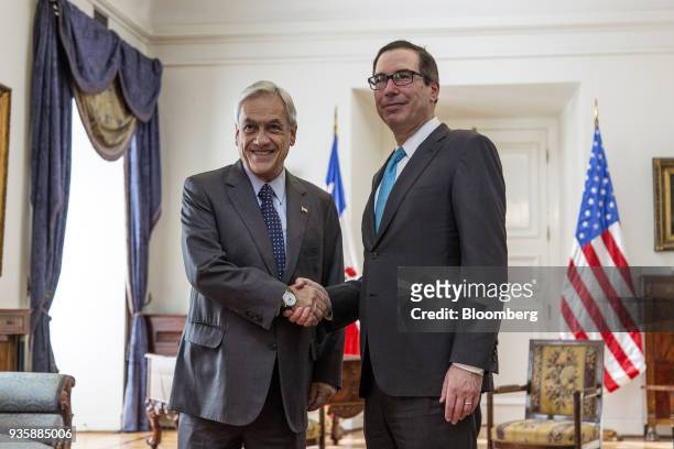 Sebastian Pinera, Chile's president, left, shakes hands with Steven Mnuchin, U.S. Treasury secretary, during a meeting at La Moneda Palace in...