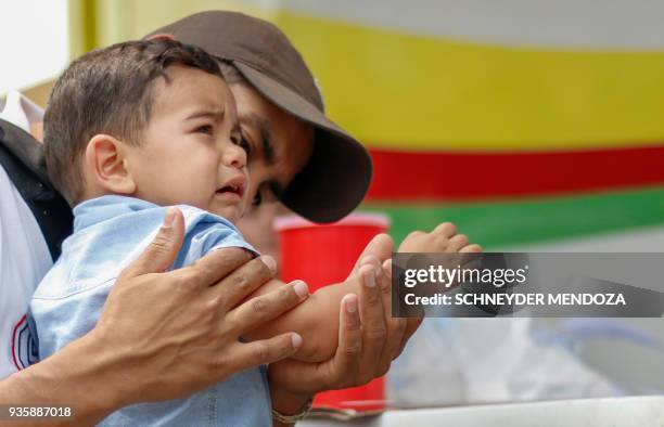 Venezuelan boy cries after being vaccinated against measles in Cucuta, Colombia, at the international brigde Simon Bolivar on the border with...