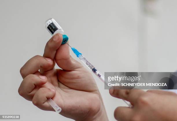 Woman prepares a syringe at a vaccination point against measles in Cucuta, Colombia, at the international brigde Simon Bolivar on the border with...