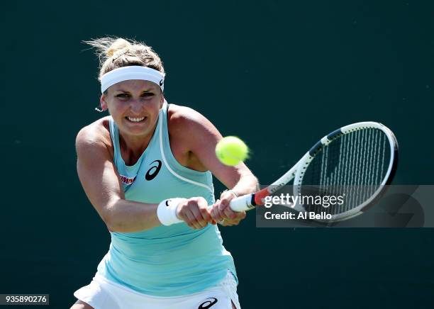 Timea Bacsinszky of Switzerland plays a shot against Ekaterina Makarova of Russia during Day 3 of the Miami Open at the Crandon Park Tennis Center on...