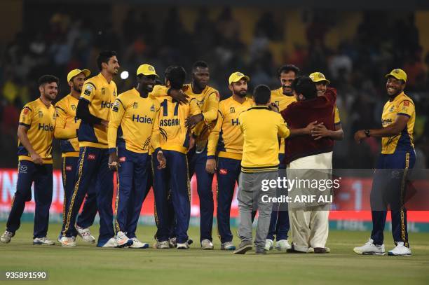 Cricketers of Peshawar Zalmi celebrate after winning the Twenty20 cricket match of the Pakistan Super League against Karachi King at The Gaddafi...