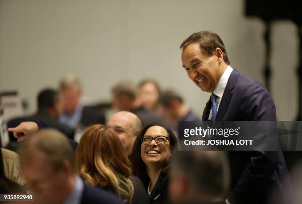 United Airlines Chief Executive Officer Oscar Munoz greets guest at the Executives' Club Program before speaking in Chicago, Illinois on March 21,...