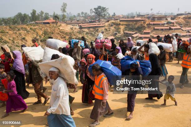 Rohingya families arrive at Kutupalong refugee camp fleeing over the border from neighbouring Myanmar on February 25, 2018 near Cox's Bazar,...