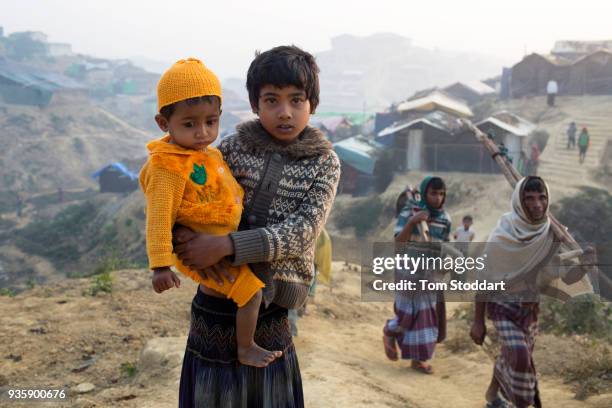 Rohingya girl and her baby brother at Kutupalong refugee camp on February 26, 2018 near Cox's Bazar, Bangladesh. Over 655,000 Rohingya have arrived...