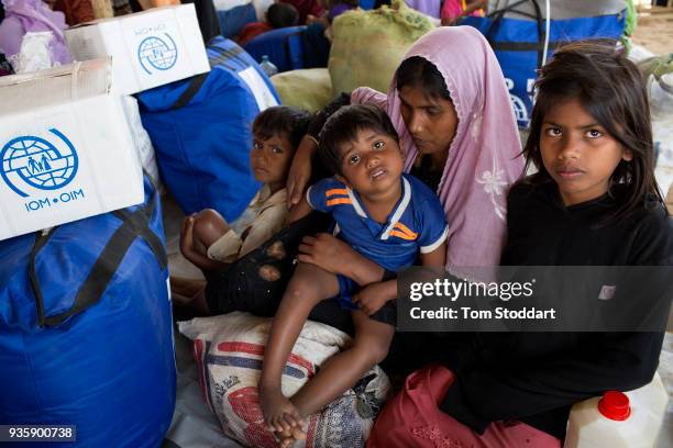 Rohingya woman and her baby boy wait for aid to be distribted by the International Organisation for Migration after arriving at Kutupalong refugee...