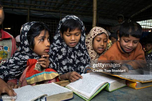 Rohingya children study the Koran at a mosque in Balukali refugee camp on February 28, 2018 at Cox's Bazar, Bangladesh. Over 655,000 Rohingya have...