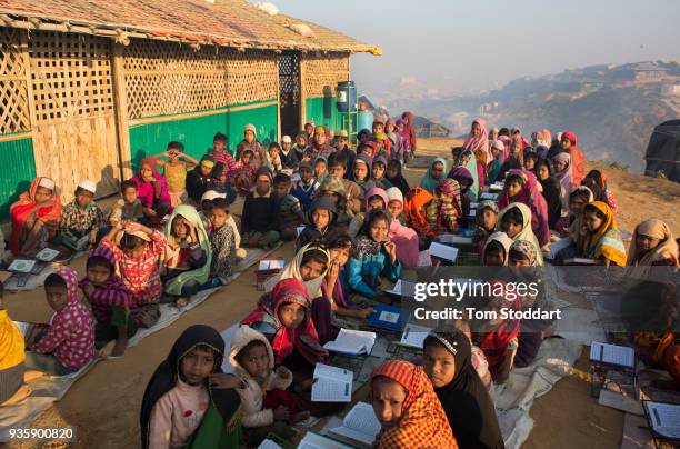 Rohingya children study the Koran at dawn outside a mosque in Kutupalong refugee camp on February 27, 2018 at Cox's Bazar, Bangladesh. Over 655,000...