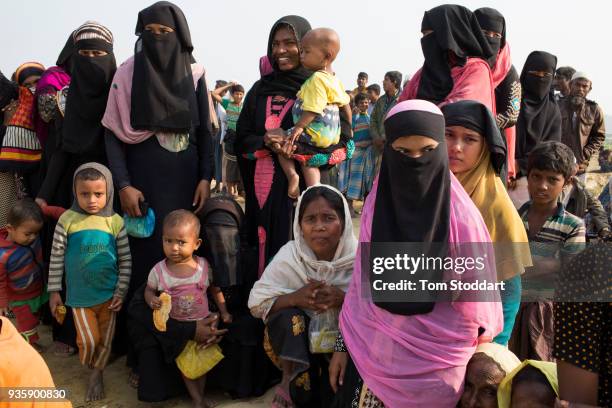 Rohingya women and their children girl wait in line at a distribution of food and blankets by the Bangladesh army at Noya Para on February 25, 2018...