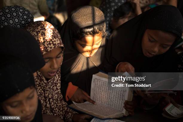 Rohingya children study the Koran at dawn at a mosque in Balukali refugee camp on February 28, 2018 at Cox's Bazar, Bangladesh. Over 655,000 Rohingya...