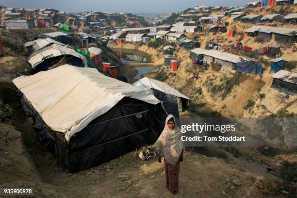 Rohingya woman stands outside her home at the Kutupalong refugee camp on February 27, 2018 at Cox's Bazar, Bangladesh. Over 655,000 Rohingya have...