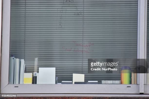 Writing is seen on the glass of a window at the London headquarters of Cambridge Analytica, London on March 21, 2018. Authorities are currently...