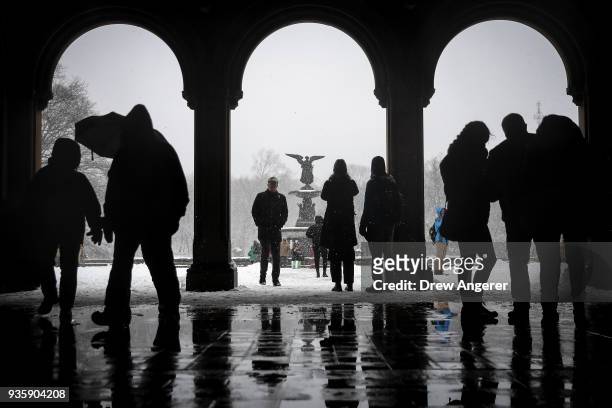 People walk near the Bethesda Fountain and Terrace in Central Park during a snowstorm, March 21, 2018 in New York City. The fourth nor'easter in...
