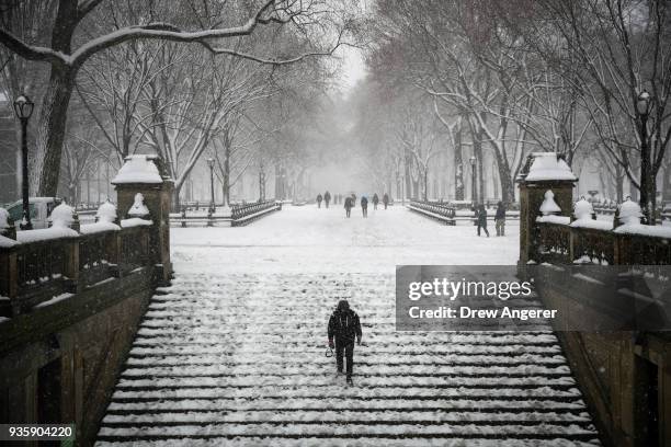 Man walks down steps toward the Bethesda Fountain and Terrace in Central Park during a snowstorm, March 21, 2018 in New York City. The fourth...