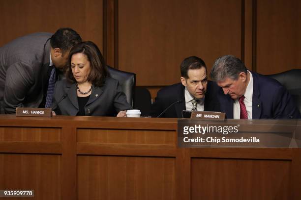 Senate Intelligence Committee members Sen. Kamala Harris and Sen. Joe Manchin hear from staff members during a committee hearing in the Hart Senate...