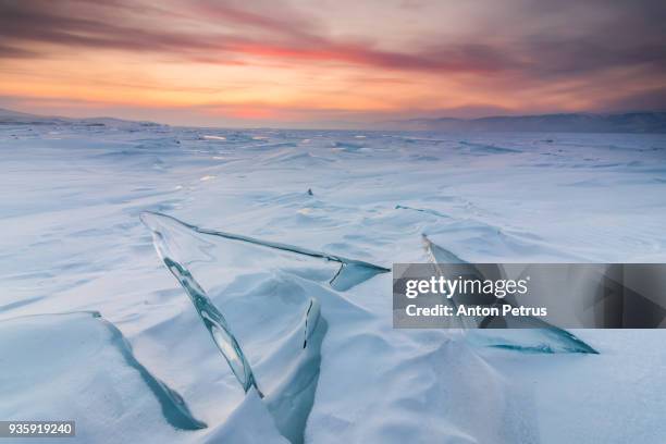 transparent ice on lake baikal at sunset - siberia imagens e fotografias de stock