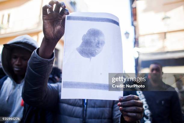 Friends of Mame attend the event with their photograph on 21 March 2018 in Madrid, Spain. AISE calls a demonstration in memory of the two Senegalese...