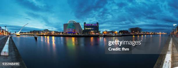 samuel beckett bridge in dublin with liffey river and city skyline (dublin/ ireland) - convention centre dublin stock pictures, royalty-free photos & images