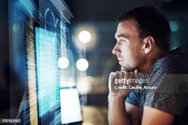 keeping his focus as he cracks the code - cloud computing stock pictures, royalty-free photos & images
