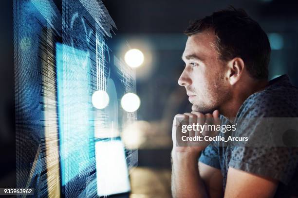 keeping his focus as he cracks the code - eficiência imagens e fotografias de stock