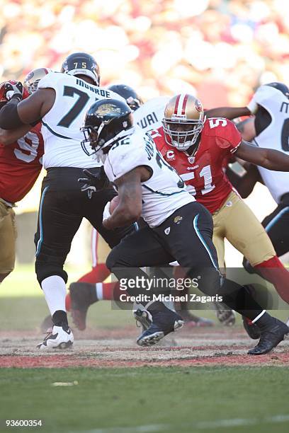 Takeo Spikes of the San Francisco 49ers chases Maurice Jones-Drew of the Jacksonville Jaguars during the NFL game at Candlestick Park on November 29,...