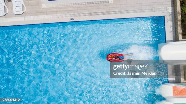 boy on water surface - children's slide stock pictures, royalty-free photos & images