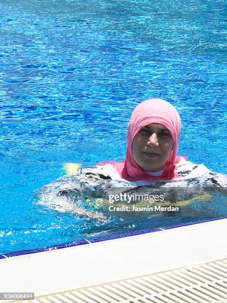muslim woman with burqini in pool - burkini bildbanksfoton och bilder