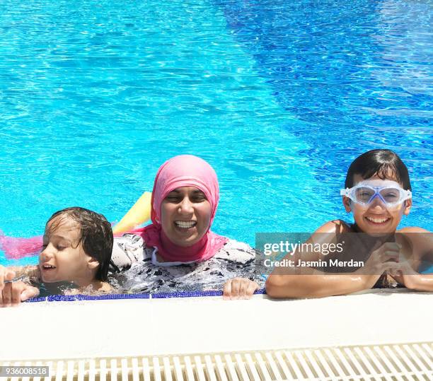 muslim woman with burqini in pool - burkini bildbanksfoton och bilder