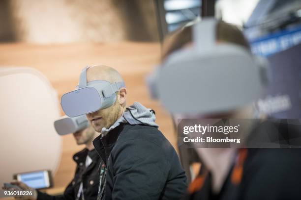 Attendees wear Oculus VR Inc. Go wireless virtual reality headsets during the Game Developers Conference in San Francisco, California, U.S., on...