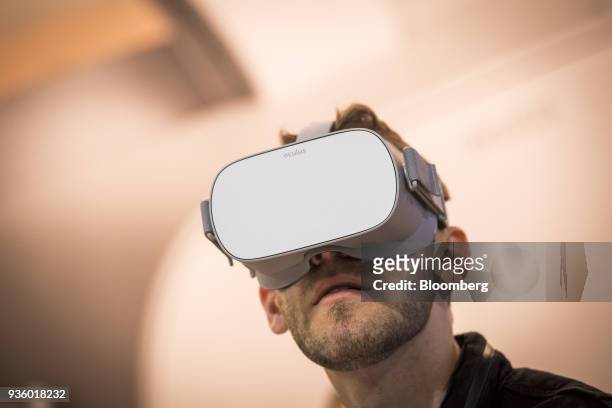 An attendee wears an Oculus VR Inc. Go wireless virtual reality headset during the Game Developers Conference in San Francisco, California, U.S., on...