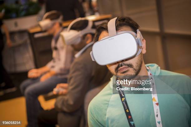 An attendee wears an Oculus VR Inc. Go virtual reality headsets during the Game Developers Conference in San Francisco, California, U.S., on...