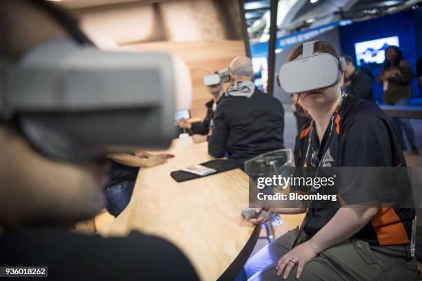 Attendees wear Oculus VR Inc. Go wireless virtual reality headsets during the Game Developers Conference in San Francisco, California, U.S., on...