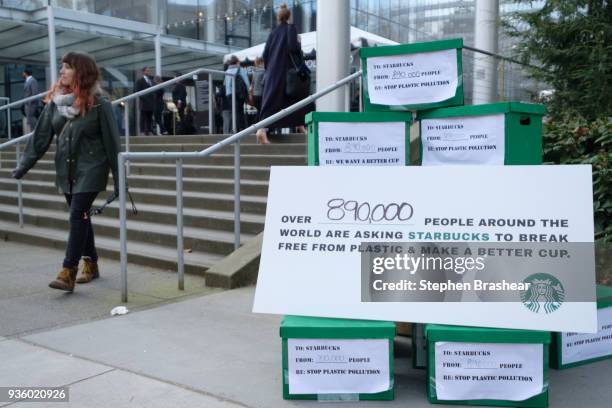 Sign encouraging Starbucks to use a more recyclable cup sits outside the company's annual shareholders meeting at McCaw Hall, on March 21, 2018 in...