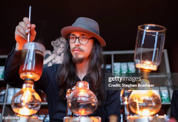 Starbucks partner Louie Posadas makes coffee using siphon brewing before the Starbucks Annual Shareholders Meeting at McCaw Hall, on March 21, 2018...