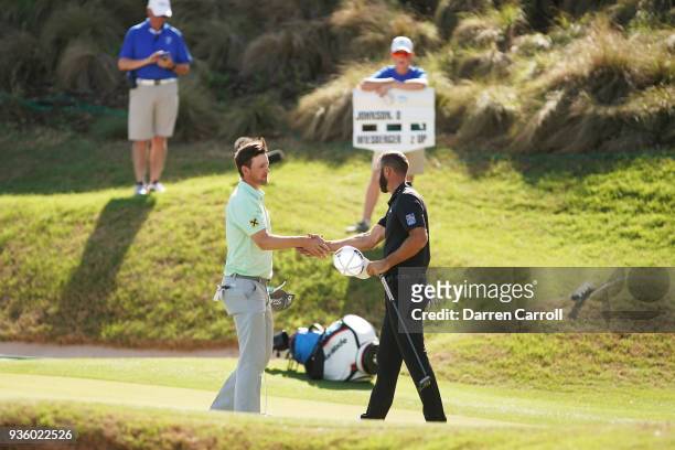 Bernd Wiesberger of Austria shakes hands with Dustin Johnson of the United States after defeating him 3&1 on the 17th green during the first round of...