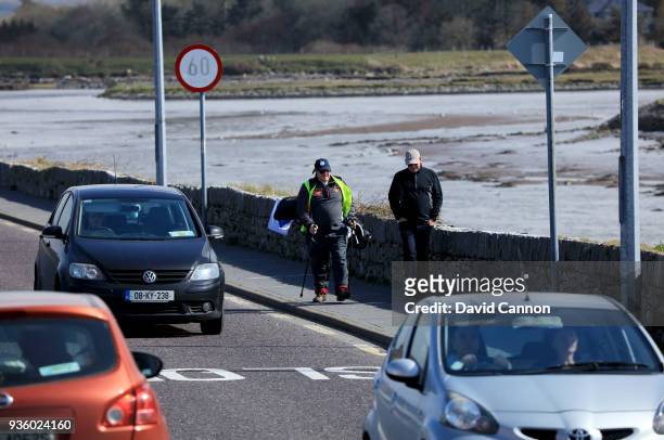 Nick Edmund of England walks towards the bridge at Blennerville with Anthony Byrne the General Manager of Tralee Golf Club on another leg of his...
