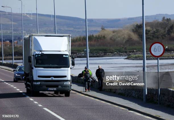 Nick Edmund of England walks towards the bridge at Blennerville with Anthony Byrne the General Manager of Tralee Golf Club on another leg of his...