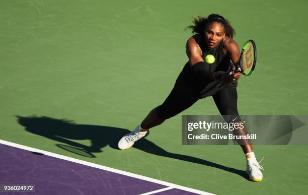 Serena Williams of the United States plays a backhand against Naomi Osaka of Japan in their first round match during the Miami Open Presented by Itau...