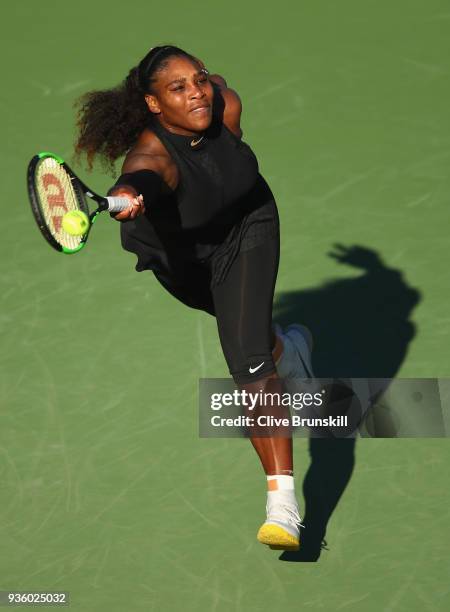 Serena Williams of the United States plays a forehand against Naomi Osaka of Japan in their first round match during the Miami Open Presented by Itau...